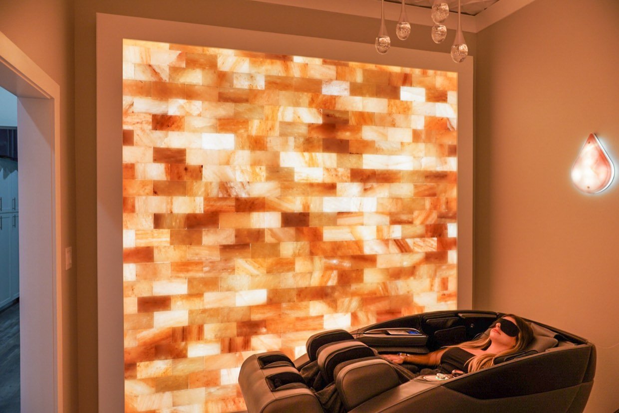 Backlit Himalayan salt wall in a wellness suite