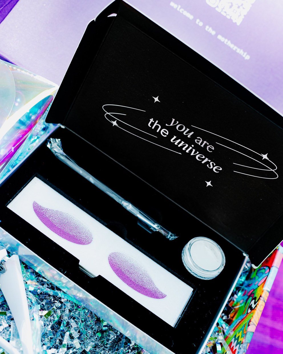 Product packaging photographed on an iridescent surface